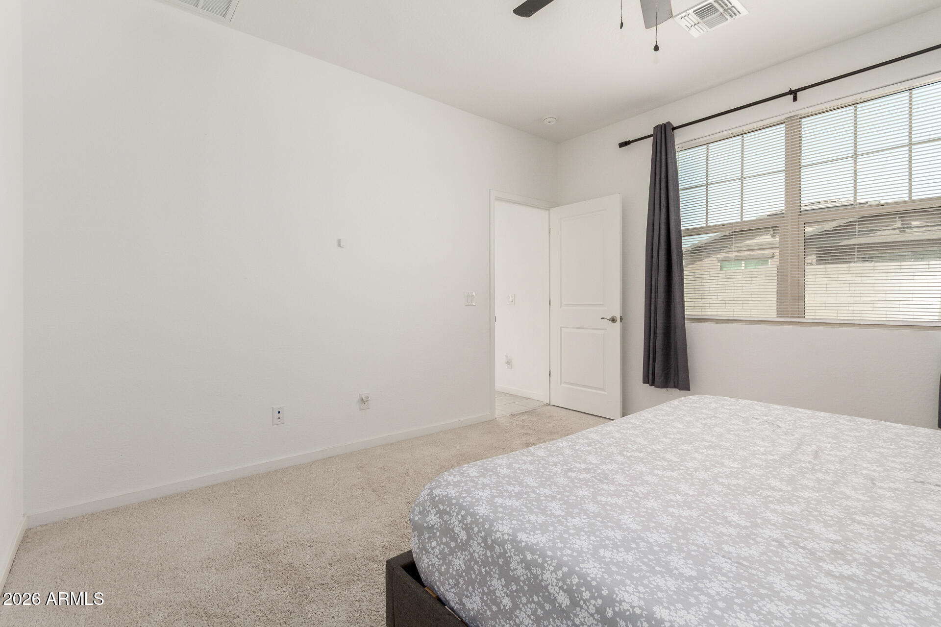 10734 West Bloch Road Tolleson, AZ 85353 - Photo 9 of 20 a bedroom with a bed and a window