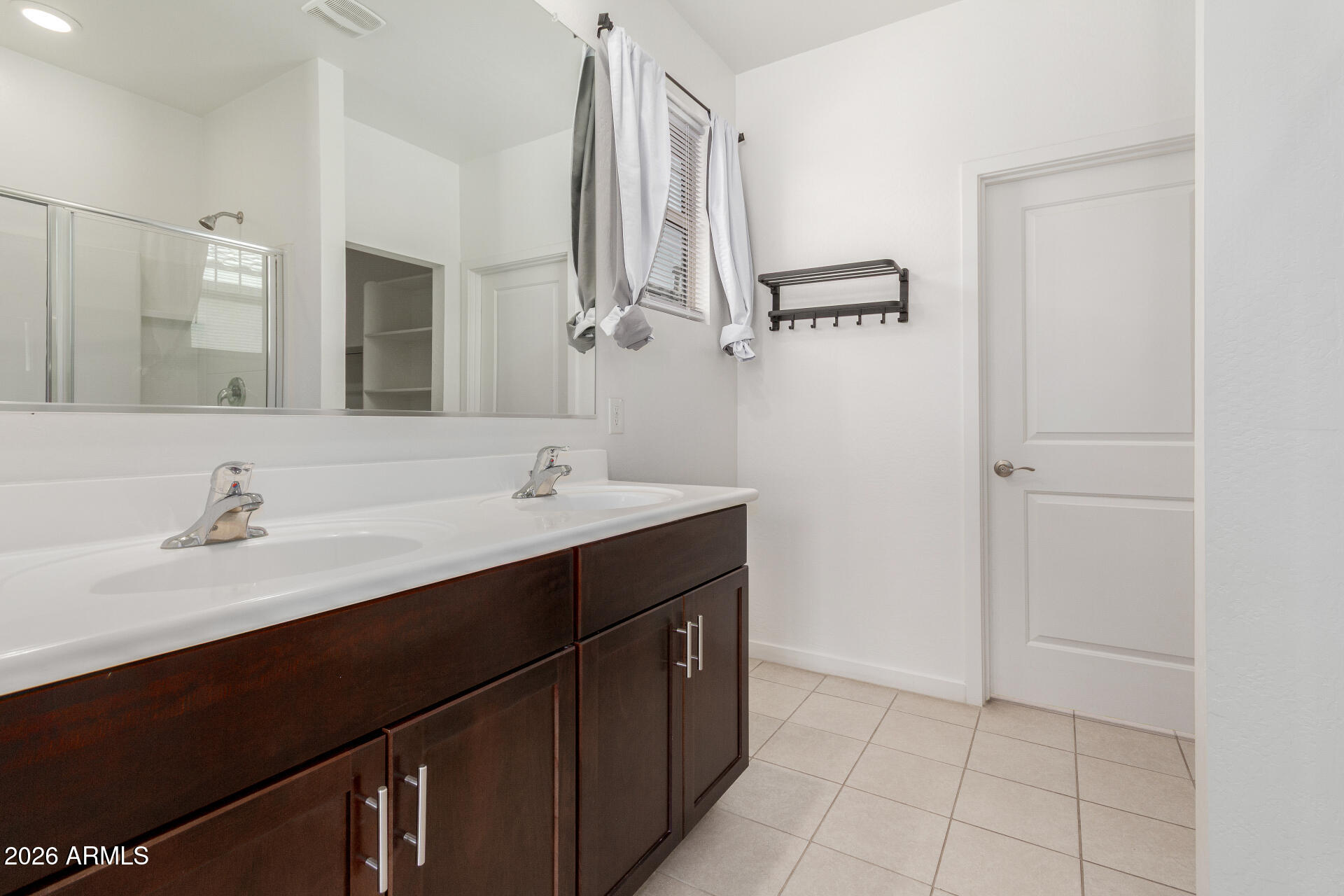 10734 West Bloch Road Tolleson, AZ 85353 - Photo 10 of 20 a bathroom with a sink and a mirror