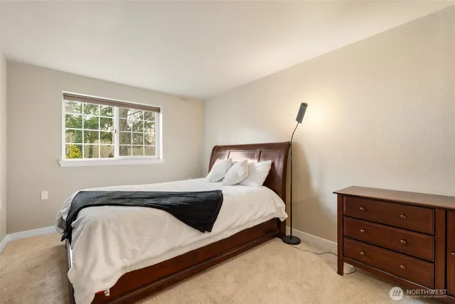 a bedroom with a bed and window