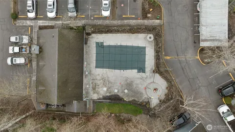 a bathroom with a granite countertop shower a mirror and bathtub
