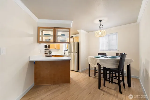 a dining room with a table chairs and kitchen view