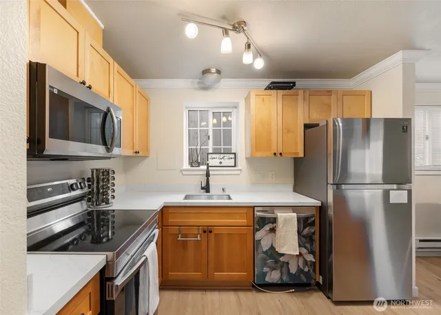 a kitchen with a sink appliances and cabinets