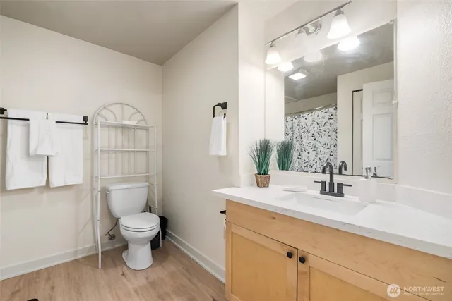 a bathroom with a sink a toilet and shower