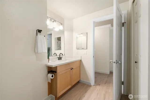 a bathroom with a sink a mirror and a shower