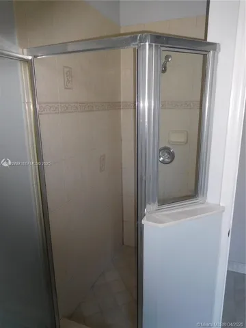 a bathroom with a glass shower door