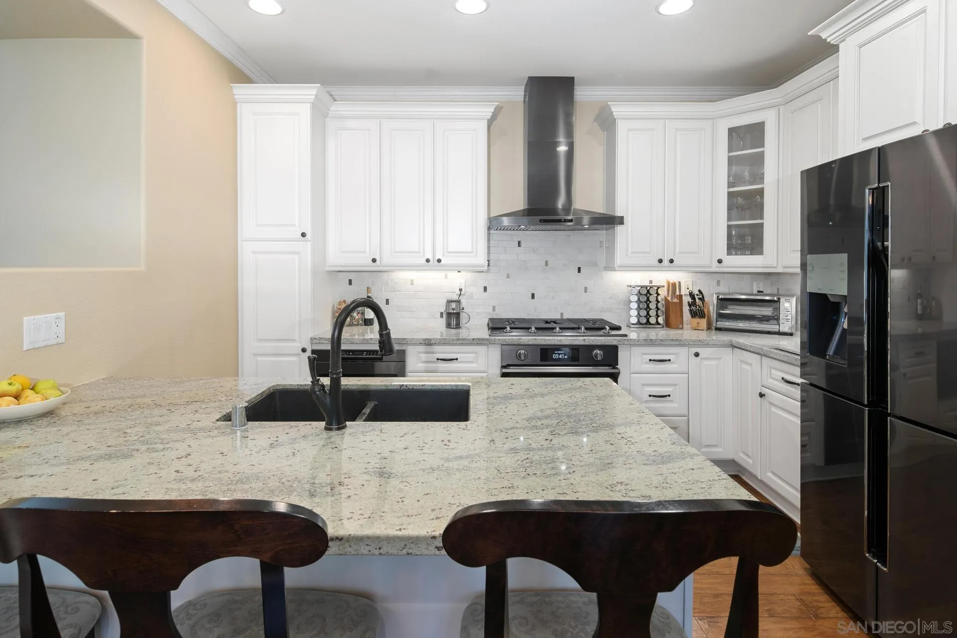 16633 Deer Ridge Road San Diego, CA 92127 - Photo 11 of 53 a kitchen with granite countertop a sink cabinets and refrigerator