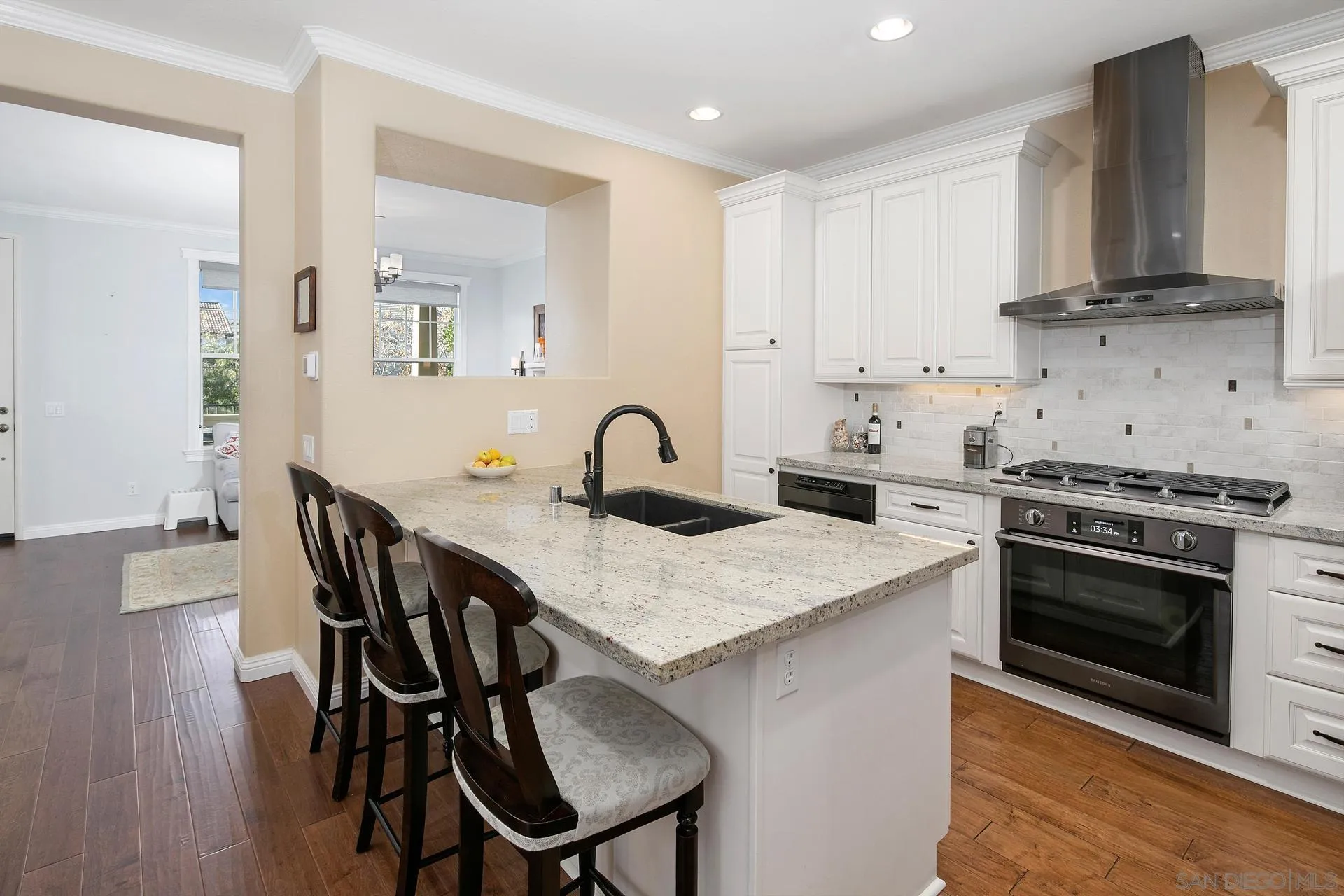 16633 Deer Ridge Road San Diego, CA 92127 - Photo 12 of 53 a kitchen with stainless steel appliances granite countertop a stove a sink dishwasher and microwave with wooden floor