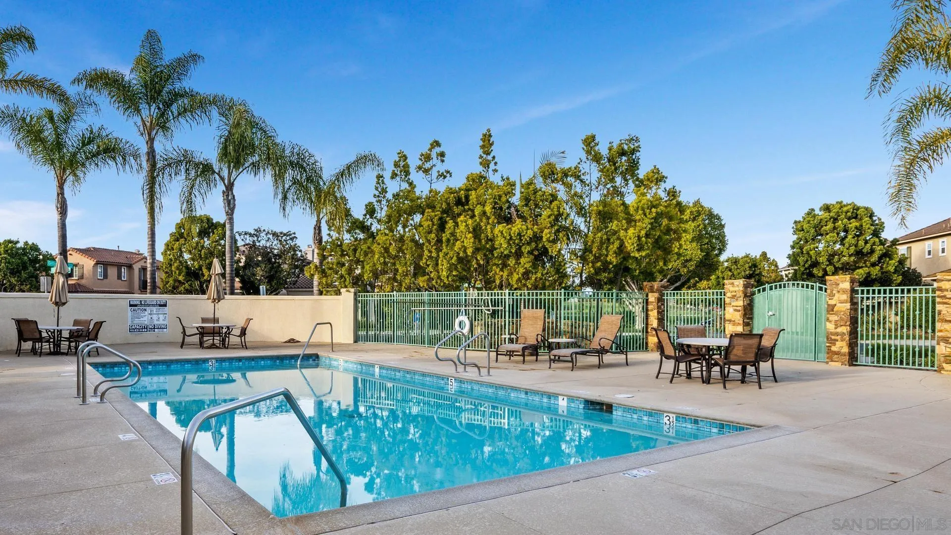 16633 Deer Ridge Road San Diego, CA 92127 - Photo 38 of 53 a view of a swimming pool with a patio and a garden