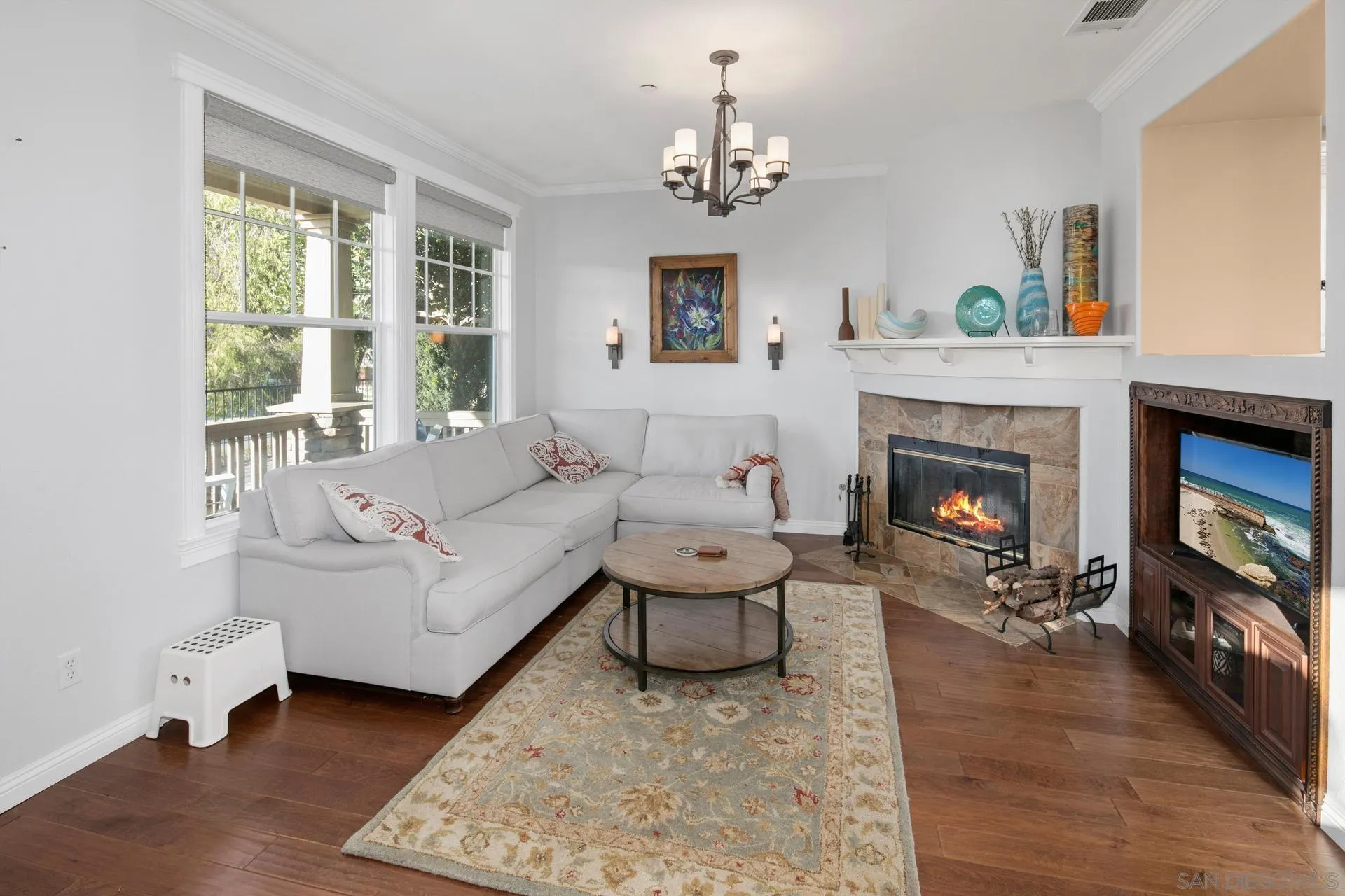 16633 Deer Ridge Road San Diego, CA 92127 - Photo 6 of 53 a living room with furniture a fireplace and a chandelier