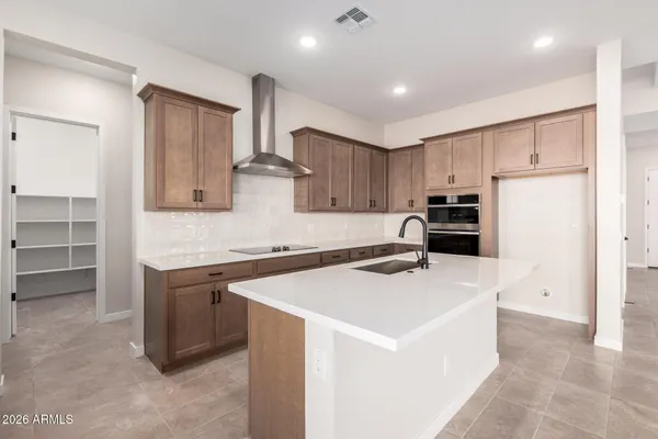 a kitchen with stainless steel appliances a refrigerator sink and cabinets