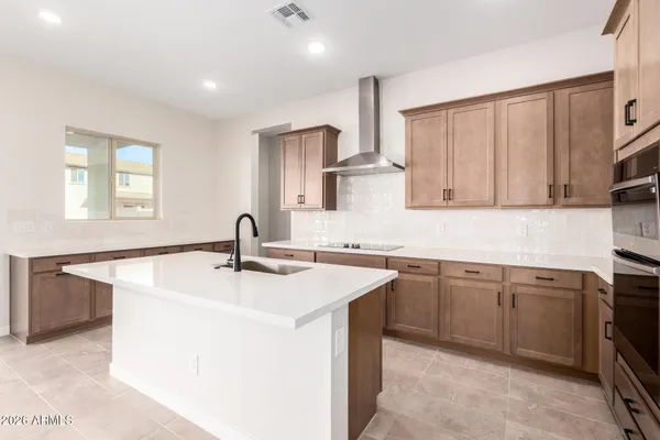 a kitchen with stainless steel appliances granite countertop a sink stove and cabinets