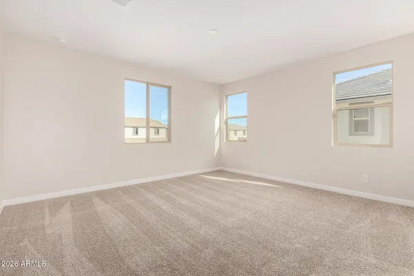 an empty room with windows and closet