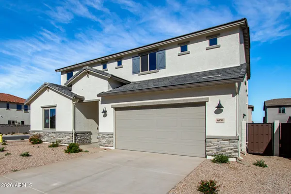 a view of a house with wooden fence