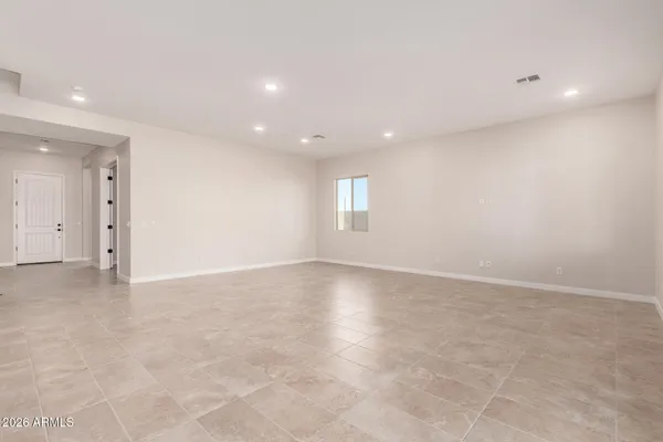 an empty room with windows and entrance