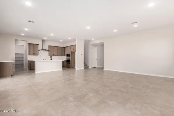 a view of a kitchen with refrigerator and a sink