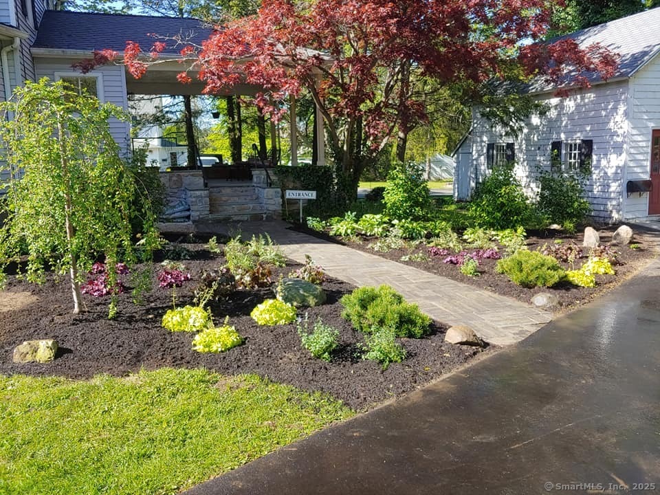 74 Park Lane Road New Milford, CT 06776 - Photo 5 of 22 a front view of a house with a yard and a garden