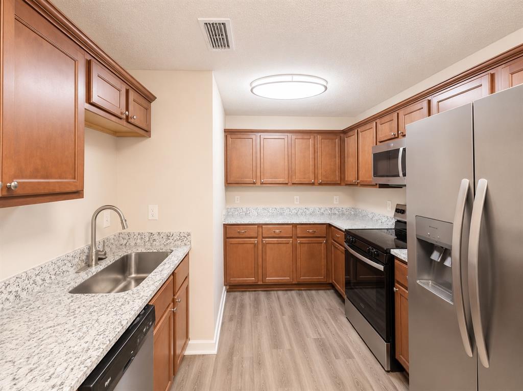 1231 Rutherford Drive Mesquite, TX 75149 - Photo 3 of 29 a kitchen with granite countertop stainless steel appliances cabinets a sink and a counter space