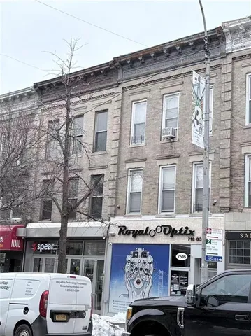 a front view of a building with parking space