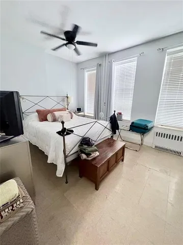 a bedroom with furniture and windows