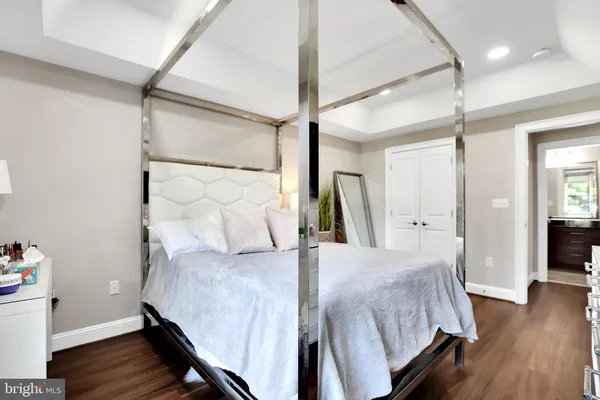 a living room with a bed and wooden floor
