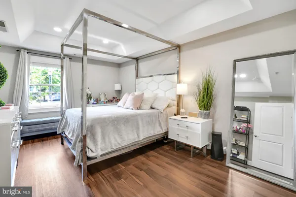 a bedroom with a bed and a large window