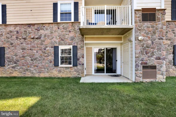a view of a house with a yard and sitting area