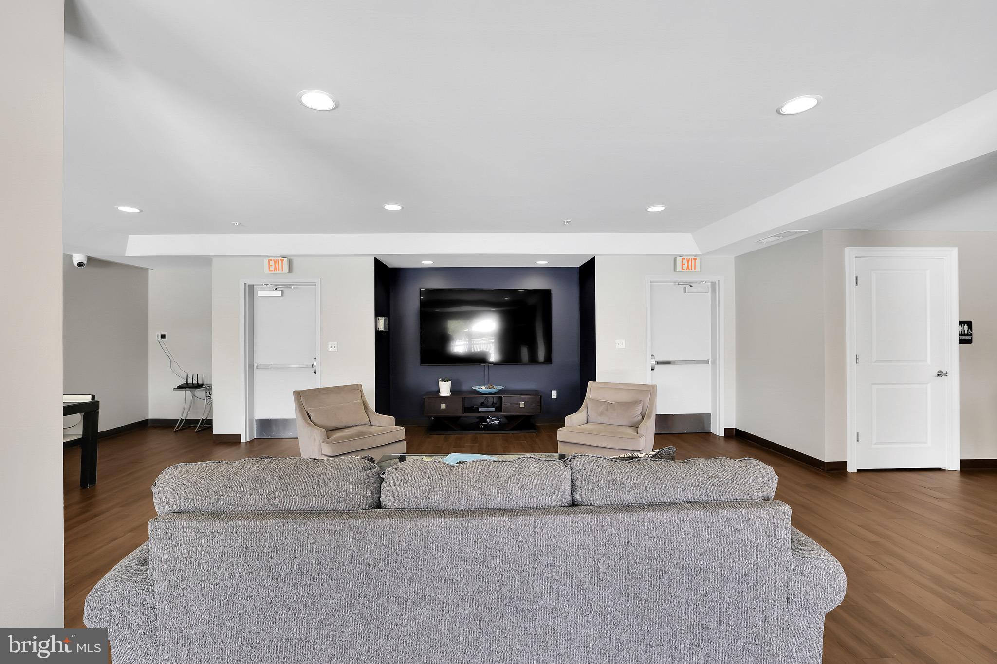 6301 Edsall Road, Unit 104 Alexandria, VA 22312 - Photo 22 of 28 a living room with furniture and a flat screen tv