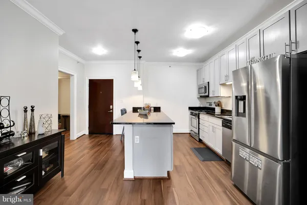 a kitchen with stainless steel appliances a refrigerator sink and microwave
