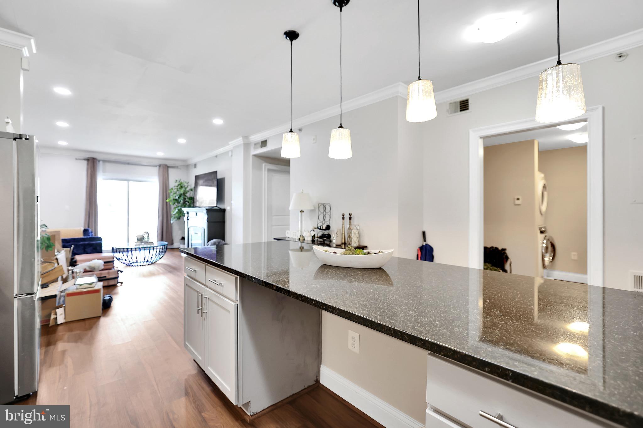 6301 Edsall Road, Unit 104 Alexandria, VA 22312 - Photo 5 of 28 a large kitchen with kitchen island a large island in it