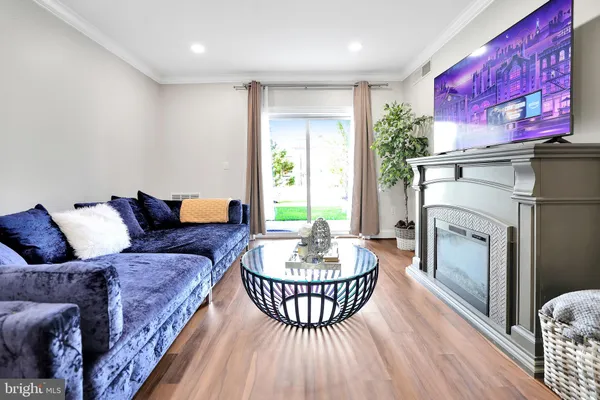 a living room with furniture a fireplace and a table