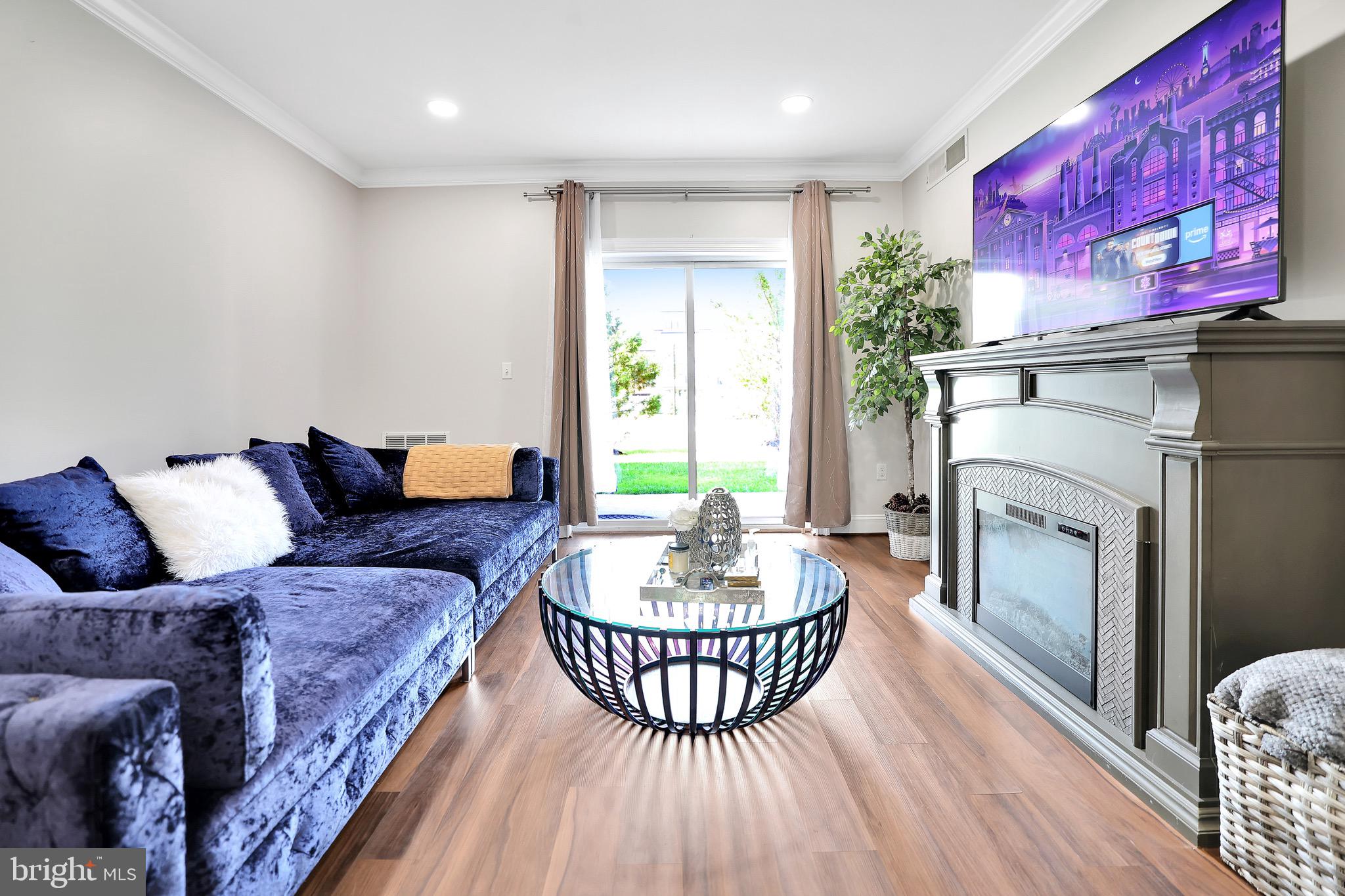 6301 Edsall Road, Unit 104 Alexandria, VA 22312 - Photo 7 of 28 a living room with furniture a fireplace and a table