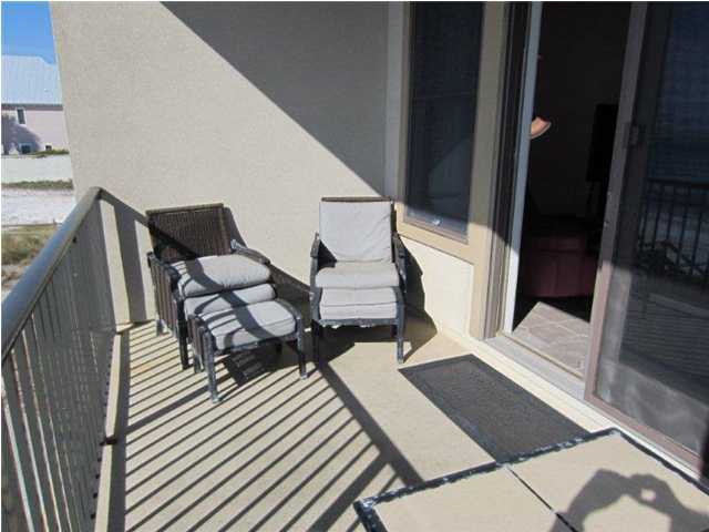 6073 West C30a Santa Rosa Beach, Unit 101 Santa Rosa Beach, FL 32459 - Photo 11 of 15 a balcony with chairs and wooden floor