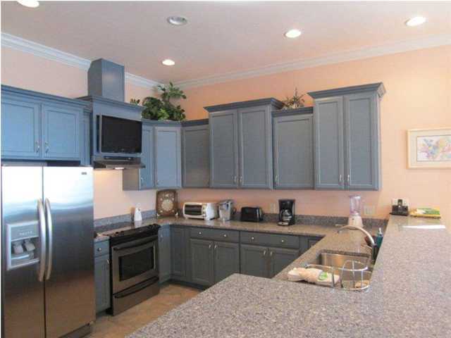 6073 West C30a Santa Rosa Beach, Unit 101 Santa Rosa Beach, FL 32459 - Photo 5 of 15 a kitchen with granite countertop a refrigerator stove and microwave