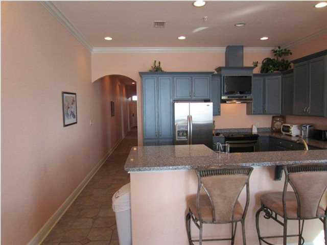 6073 West C30a Santa Rosa Beach, Unit 101 Santa Rosa Beach, FL 32459 - Photo 6 of 15 a kitchen with kitchen island granite countertop a sink and counter space