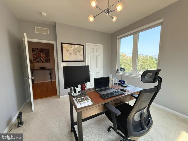a work room with furniture and large window