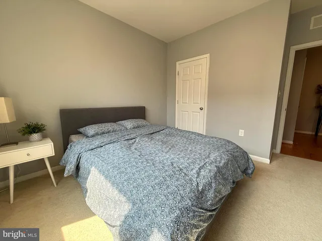 a bedroom with a bed and a table in it