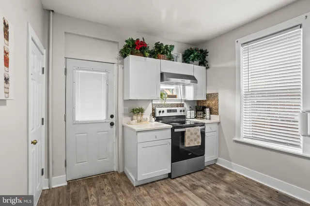 a kitchen with stainless steel appliances a white stove top oven and a refrigerator