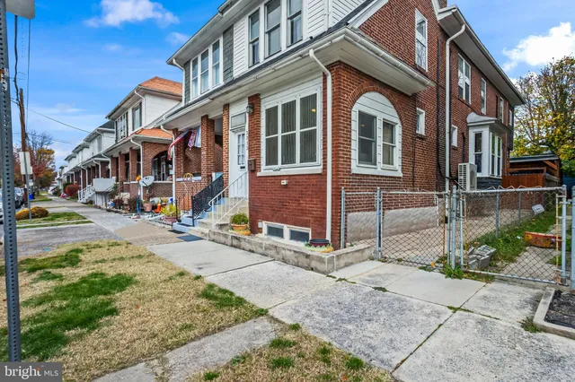 a front view of a residential apartment building with a yard