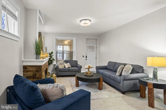 a living room with furniture and a lamp