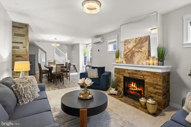 a living room with furniture and a fireplace