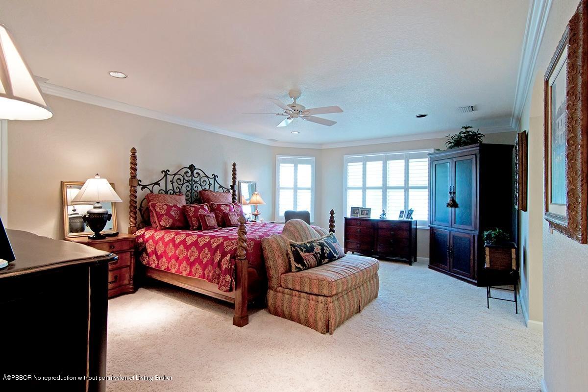 338 Southwest 16th Street Boca Raton, FL 33432 - Photo 13 of 31 a spacious bedroom with a bed and a chandelier