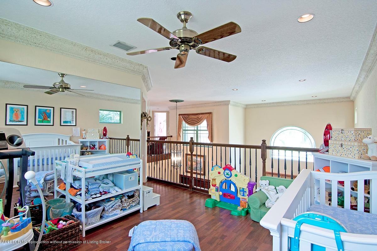 338 Southwest 16th Street Boca Raton, FL 33432 - Photo 22 of 31 a bedroom with furniture a baby crib and a chandelier