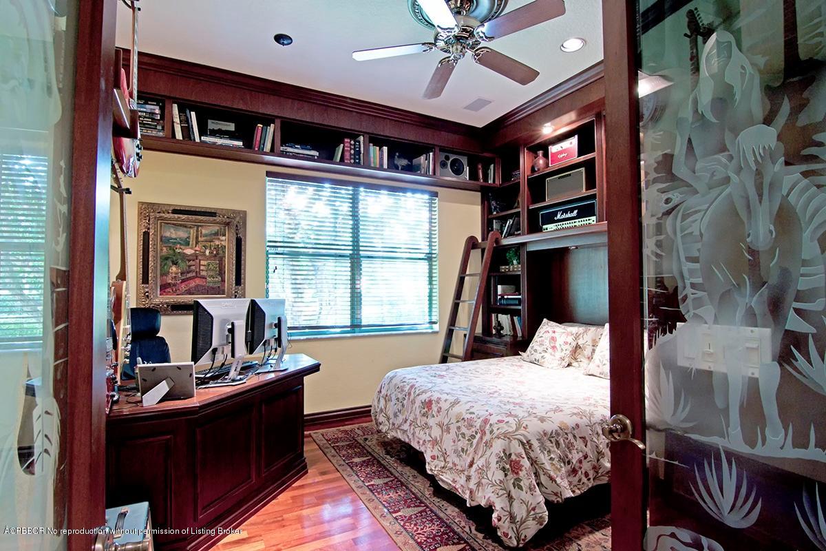 338 Southwest 16th Street Boca Raton, FL 33432 - Photo 27 of 31 a bed room with a bed and a chandelier