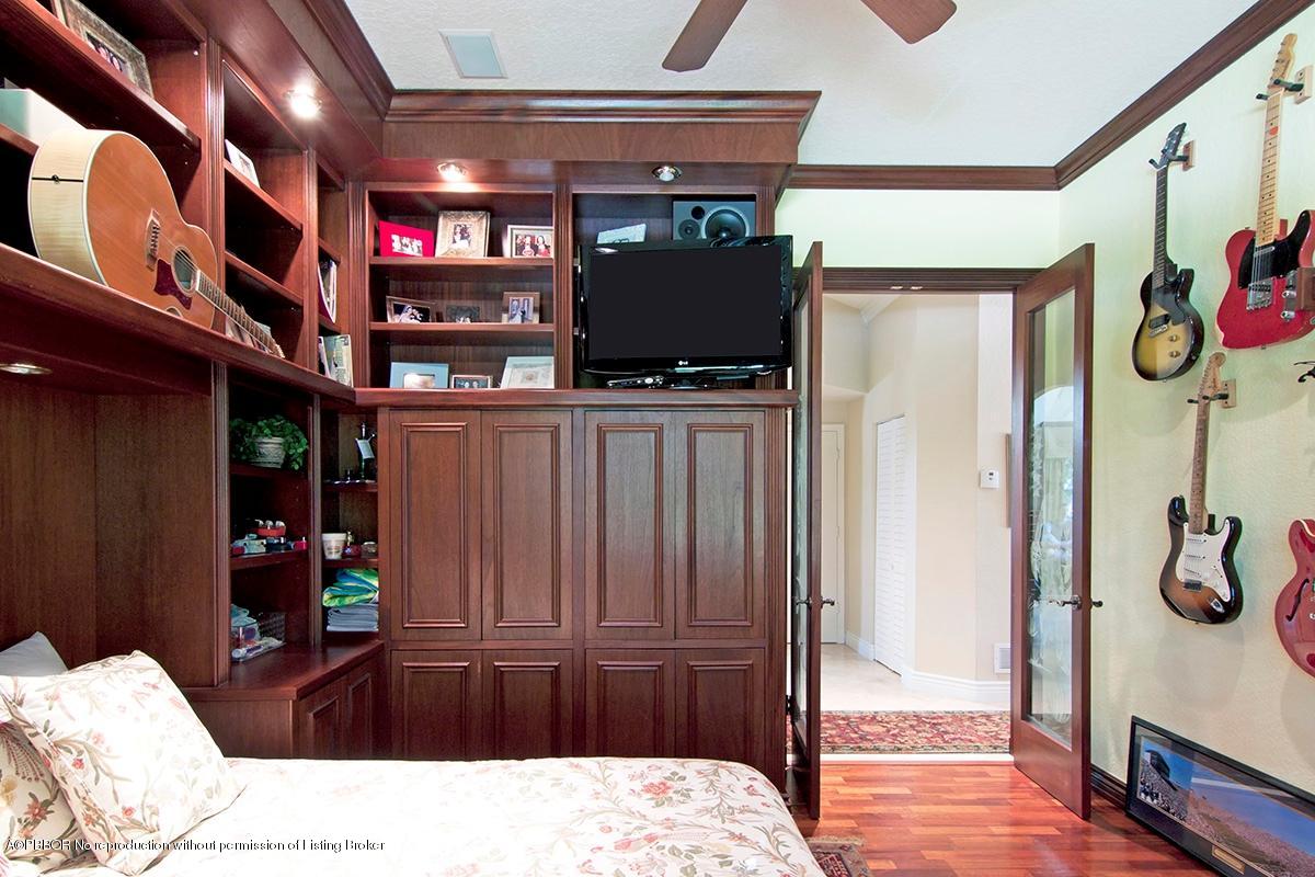 338 Southwest 16th Street Boca Raton, FL 33432 - Photo 28 of 31 a bedroom with a bed and a chandelier