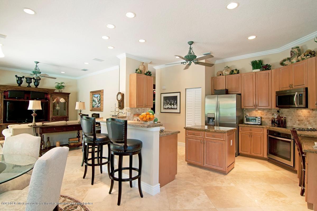 338 Southwest 16th Street Boca Raton, FL 33432 - Photo 5 of 31 a kitchen with stainless steel appliances kitchen island granite countertop a table chairs microwave and sink