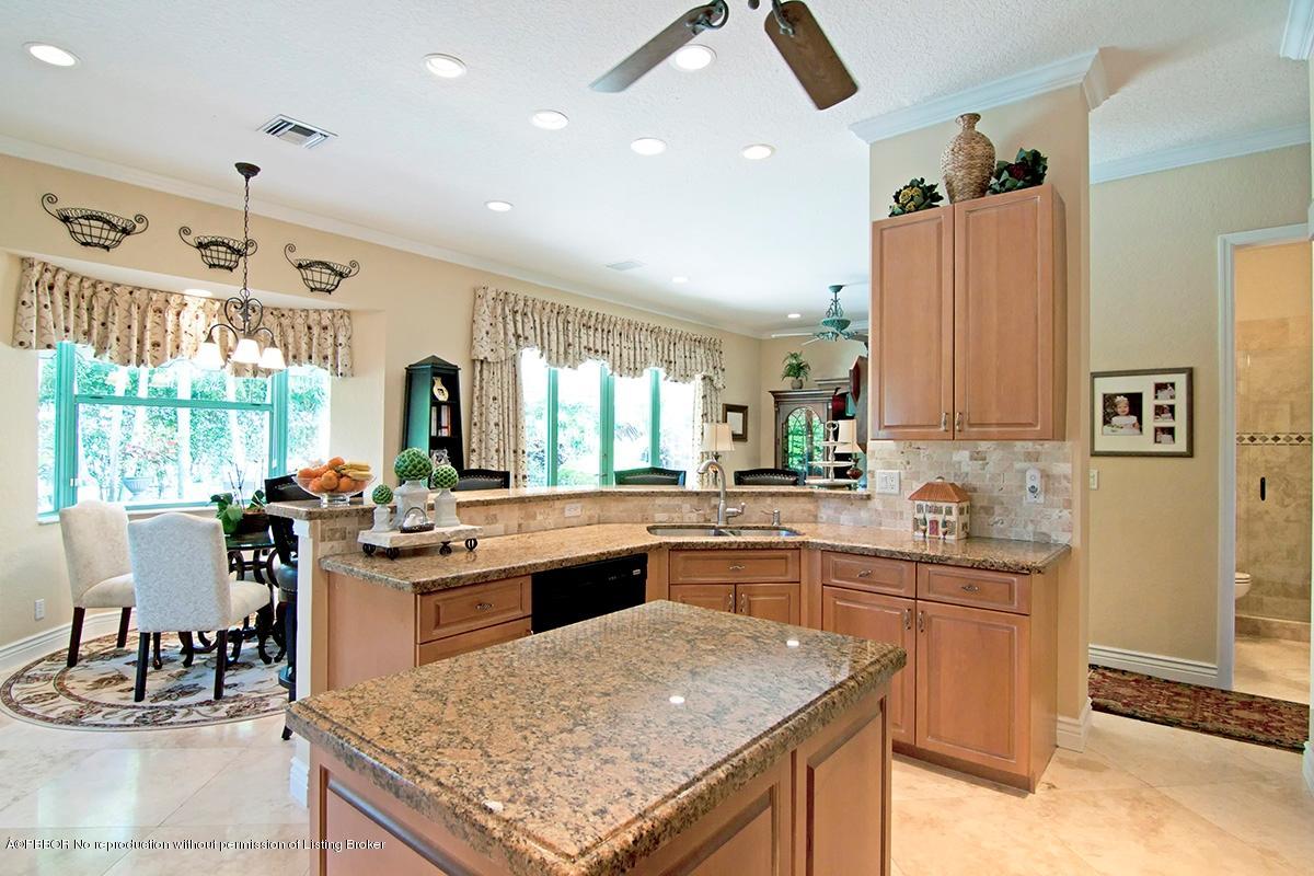 338 Southwest 16th Street Boca Raton, FL 33432 - Photo 7 of 31 a kitchen with stainless steel appliances granite countertop a sink and cabinets
