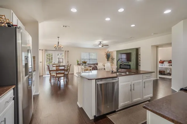 a kitchen with stainless steel appliances kitchen island granite countertop a sink and cabinets