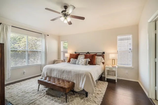 a bedroom with a bed window and a table
