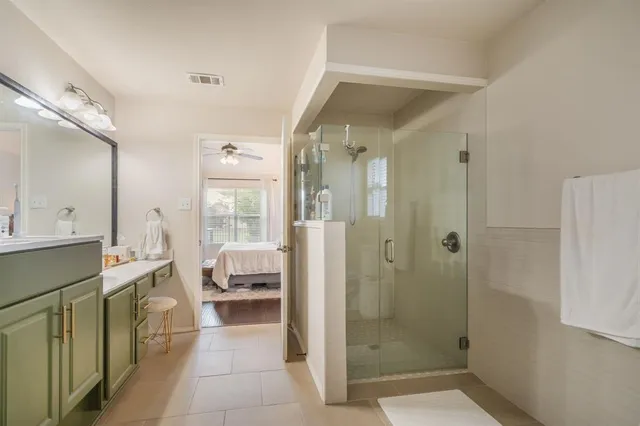 a bathroom with a tub shower and sink