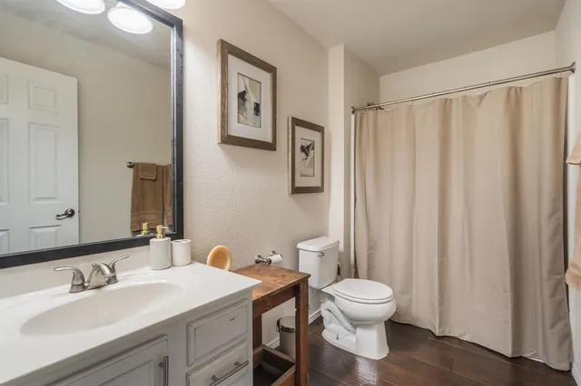 a bathroom with a toilet a sink and a mirror